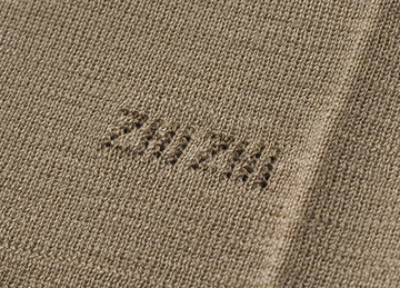 Seamless Wool Crewneck in Warm Grey Beige - detail knitted signature - Warm Grey Beige